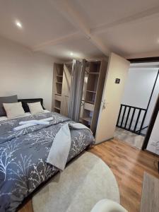 a bedroom with a large bed and a balcony at MAISON LA SOURCE d'hôte à Roubaix in Roubaix