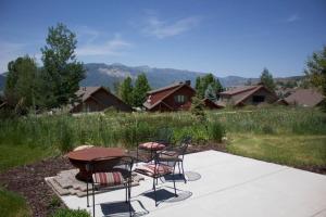 a patio with two chairs and a table and a table at Powder Mtn Wolf Den TR11Mtn Biking Dog Friendly in Eden
