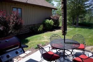 a patio with a table and chairs and a grill at Powder Mtn Wolf Den TR11Mtn Biking Dog Friendly in Eden