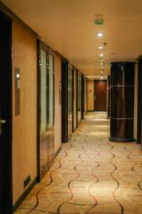 an empty hallway in a building with ailed floor at Peninsula Grand in Mumbai +48 photos