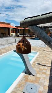 a chocolate item sitting on top of a swimming pool at Vila Lençóis Residence in Santo Amaro