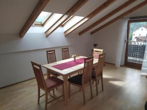 a dining room with a table and chairs at Ferienwohnung Hofmann mit Balkon und Donaublick in Obernzell