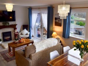 a living room with a couch and a table at Dream Cottage in Strathyre
