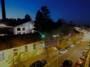 a city street at night with a green traffic light at Cetinjska apartment in Belgrade
