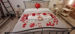 a bedroom with a bed with red roses on it at Suite Grotta della luna - Romantic Luxury Jacuzzi in Ostuni