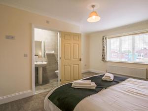 a bedroom with a bed with two towels on it at 2 Dawson Court - Uk33411 in Mablethorpe