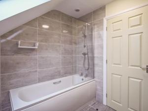 a bathroom with a white tub and a shower at 2 Dawson Court - Uk33411 in Mablethorpe