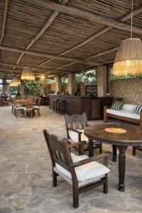 a resort lobby with tables and chairs and a bar at Lawford Apartment Malindi in Malindi