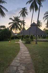 a path in front of a resort with palm trees at Lawford Apartment Malindi in Malindi