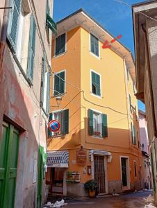 a yellow and orange building on a street at Il Glicine B&b in Voltaggio