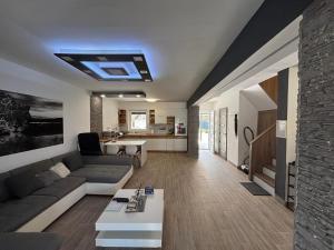 a living room with a couch and a table at LUX Pool Villa Zamárdi in Zamárdi
