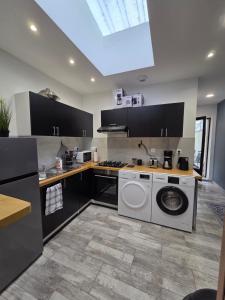 a kitchen with a washer and dryer in it at MAISON LA SOURCE d'hôte à Roubaix in Roubaix