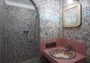 a bathroom with a sink and a mirror at RiadAtlasChateau in Imlil