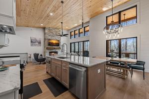 a kitchen with a large island and a dining room at Timber Haven in Blue Ridge