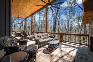 a screened in porch with chairs and a table at Timber Haven in Blue Ridge