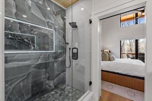 a bathroom with a walk in shower next to a bedroom at Timber Haven in Blue Ridge +46 photos