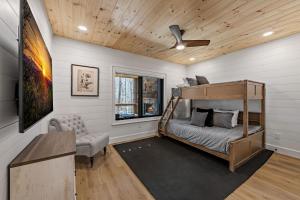 a bedroom with a bunk bed and a chair at Timber Haven in Blue Ridge