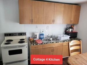 a kitchen with a white stove and a sink at Cottage 4 Duplex In Eckman ATV Fun and Rentals! in Northfork +16 photos