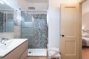 a bathroom with a sink and a shower at Albergo Ristorante Locanda Rosella in Giba +50 photos
