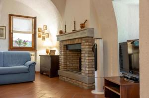 a living room with a fireplace and a tv at Casa C'era una volta in Costa Volpino