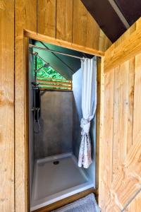 a small room with a window and a curtain at Les insolites de la Ferme de Froidefontaine in Havelange +35 photos