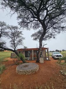 a house with a tree in front of it at Troupant - Luxury Bush Unit in Askham