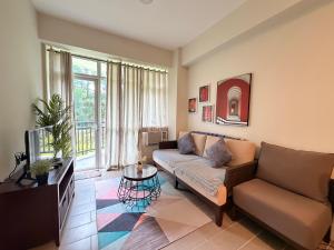 a living room with a couch and a tv at Oceanview Condo in Boracay in Boracay