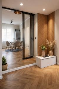a living room with a table and a dining room at Apartament by DANIA&PETRU in Târgu Ocna