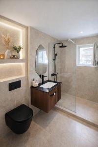 a bathroom with a toilet and a glass shower at Apartament by DANIA&PETRU in Târgu Ocna