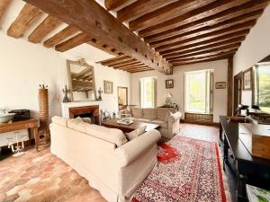 a living room with two couches and a table at Former riverside rectory in Nanteau-sur-Lunain