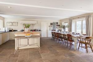 a kitchen and dining room with a table and chairs at Week Farm Manor in Wellow