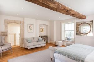a bedroom with a bed and a living room at Week Farm Manor in Wellow