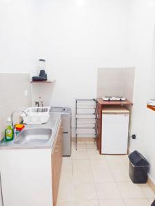 a small kitchen with a sink and a refrigerator at comodo alojamiento centro Histotico cartagena - 3 in Cartagena de Indias