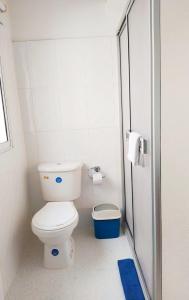 a small bathroom with a toilet and a blue rug at comodo alojamiento centro Histotico cartagena - 3 in Cartagena de Indias