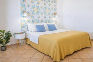 a bedroom with a large bed with a yellow blanket at Villa Raf in Vico Equense