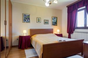 a bedroom with a bed with purple curtains and a window at Villa Sofia with Private Pool in Pazin +40 photos