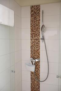 a bathroom with a shower with a sink at Hotel Sonnenklause in Travemünde +77 photos