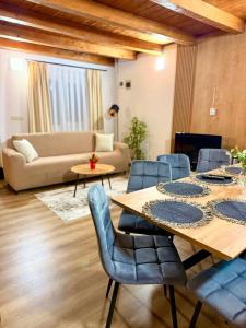 a living room with a table and chairs and a couch at Cabana Vladimir in Cucuceni