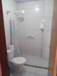 a bathroom with a toilet and a shower at Apartamento in Parnamirim
