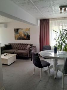 a living room with a couch and a table at Căsuța galbenă in Bucharest