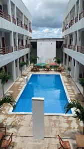 a large swimming pool in the middle of a building at Apartamento a 50m da praia em Camocim CE in Camocim