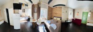 a living room with a couch and a brick wall at Apart-Hotel IGORIVSKA in Kyiv