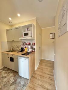 a kitchen with a sink and a microwave at Przy Parku Róż II in Chorzów