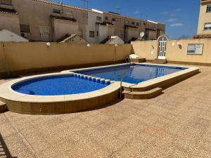 a swimming pool on the roof of a building at BEACH AND CHILL APARTMENT con encanto in Los Alcázares +16 photos