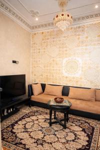 a living room with a couch and a table at Luxury apartment and duplex in Ouarzazate