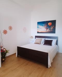 a bedroom with a large bed in a white room at REGINA ANNA HOME in Bari +7 photos