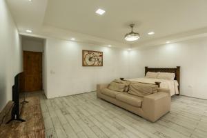 a living room with a couch and a bed at Catalinas Cozy Room in Fortuna