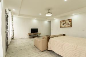 a bedroom with a bed and a flat screen tv at Catalinas Cozy Room in Fortuna