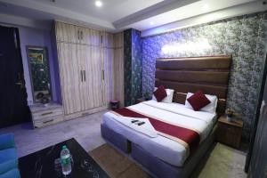 a bedroom with a large bed in a room at Hotel Yuvraj 5 Mints walking from Rajendra Nagar Metro Station in Ghaziabad