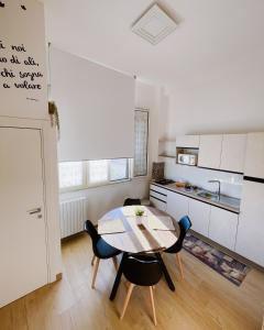 a kitchen with a table and chairs in a room at REGINA ANNA HOME in Bari